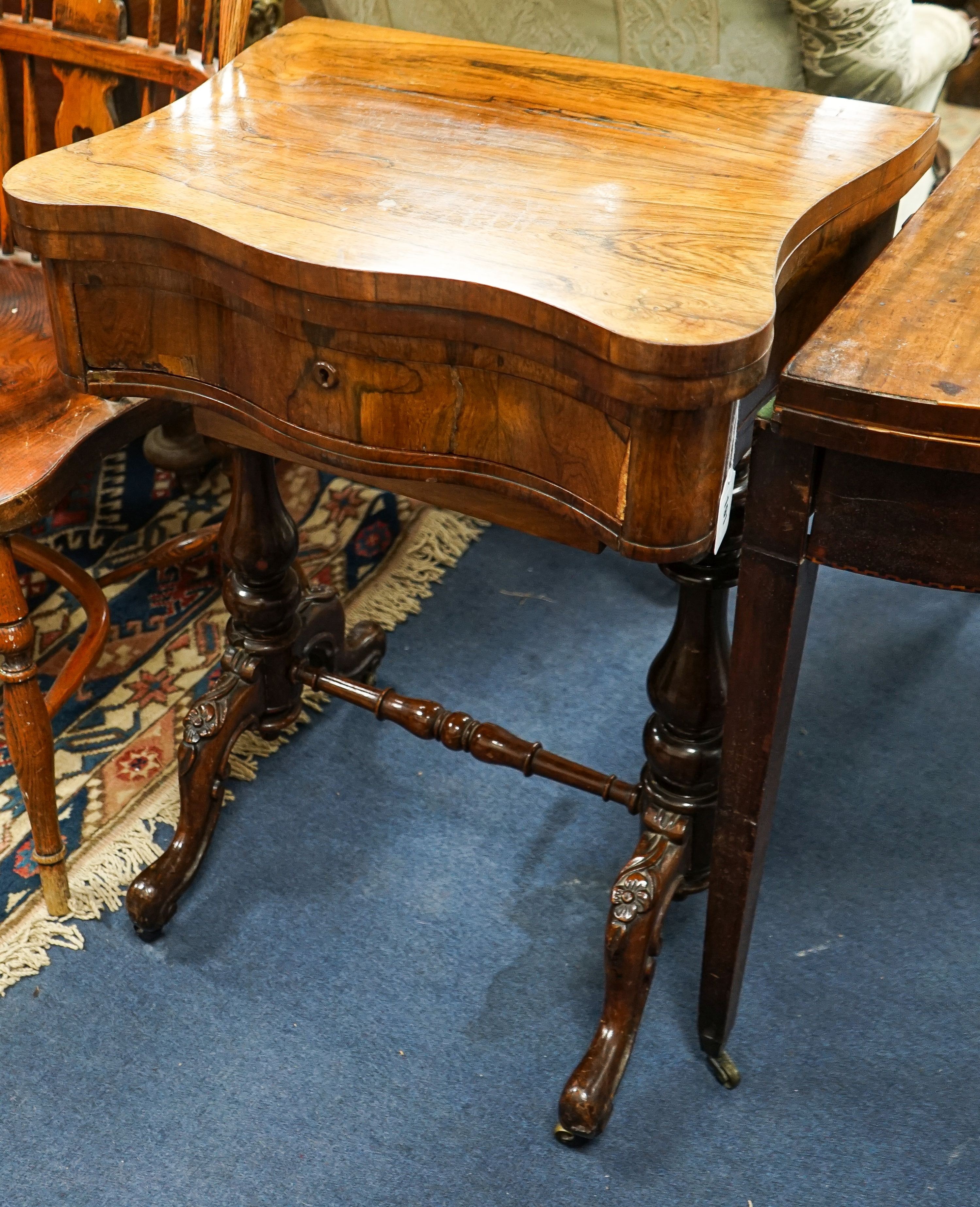A Victorian rosewood serpentine games / work table with parquetry inlaid interior, width 55cm, depth 42cm, height 76cm